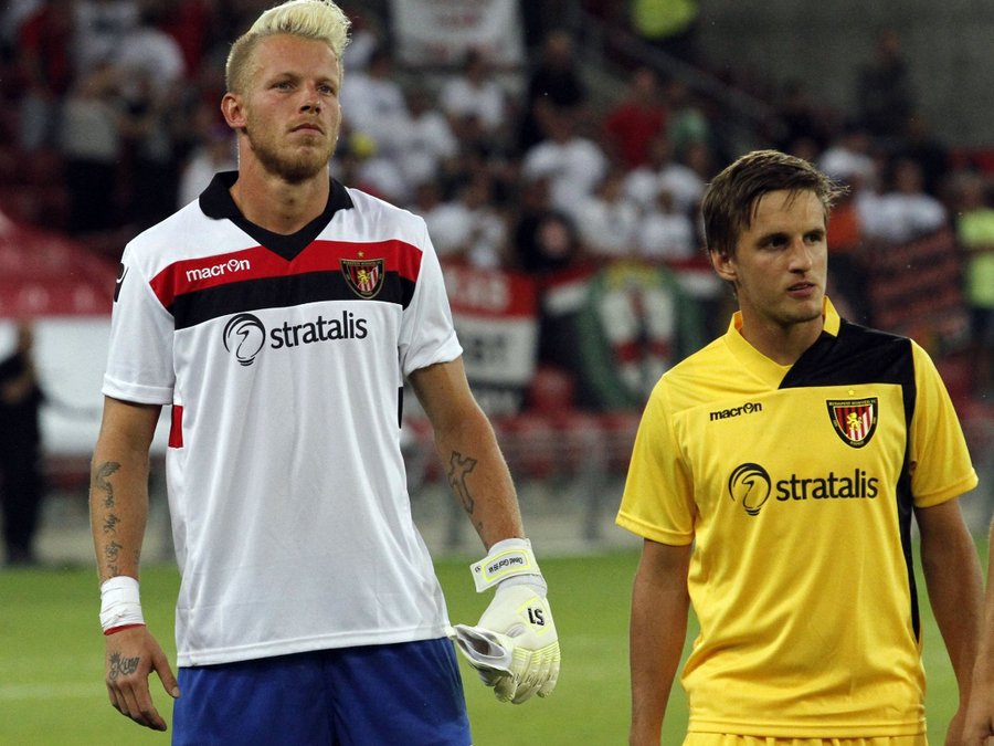 Football players wearing Stratalis-sponsored club jerseys during a match
